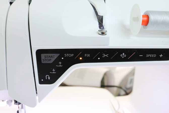 Function panel of the sewing machine with the FIX function light activated