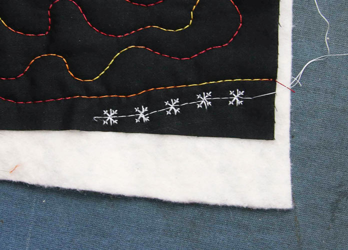 F:7 - a snowflake stitched on the scrap quilt sandwich