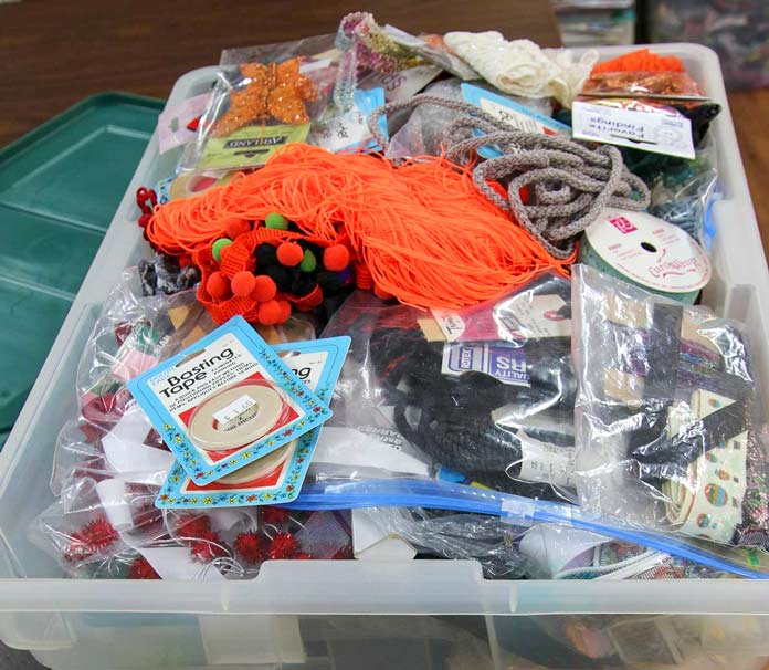 A well-stocked tub of embellishing supplies