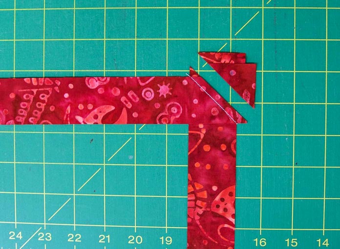 Trim the excess corners (and selvages) away leaving ¼" seam allowance