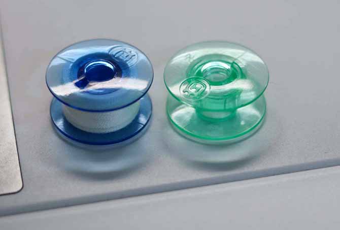 Blue bobbin (Designer EPIC) is 30% larger than the green bobbins