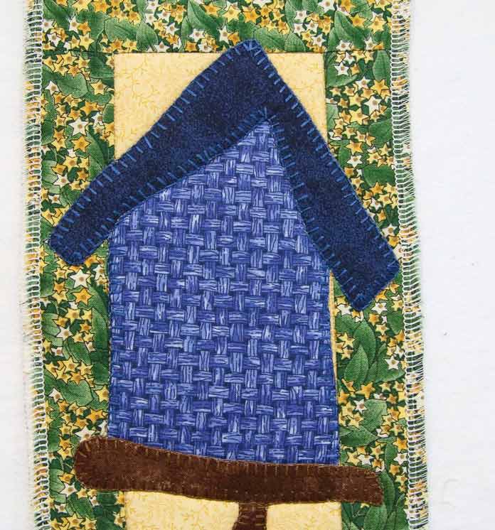 Quilting stitches are still invisible in the blue sections of the wall hanging