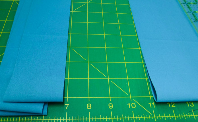 Keep the fold in the fabric close to you when cutting from yardage