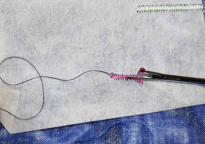 Use the seam ripper to slice open the back of the satin stitch to rip it out