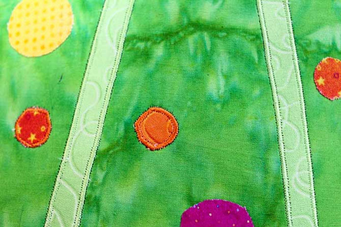 Even small circles are easy to stitch with the Sensor Foot and Needle Stop Up/Down. An important thing to remember with applique - if you don't start with a perfect circle of fabric - then you won't get a perfect circle for the stitching!