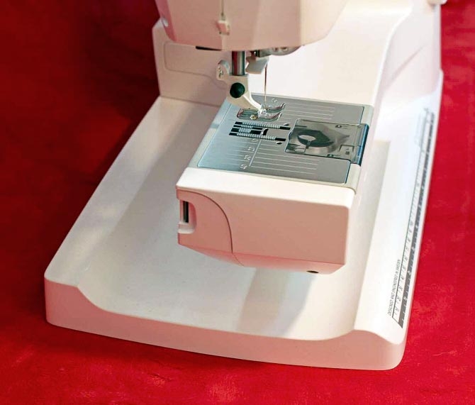 Once the tool box is removed from the back of the sewing machine, the free arm of the machine is exposed and ready for stitching in those tight spots.