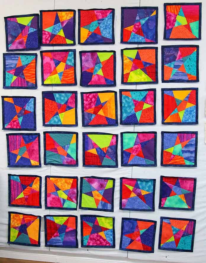 A narrow frame has been sewn to all the wonky star quilt blocks.