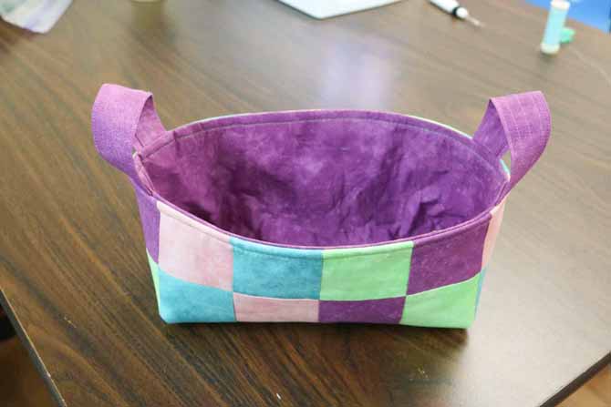 Basket with a topstitched edge around the top