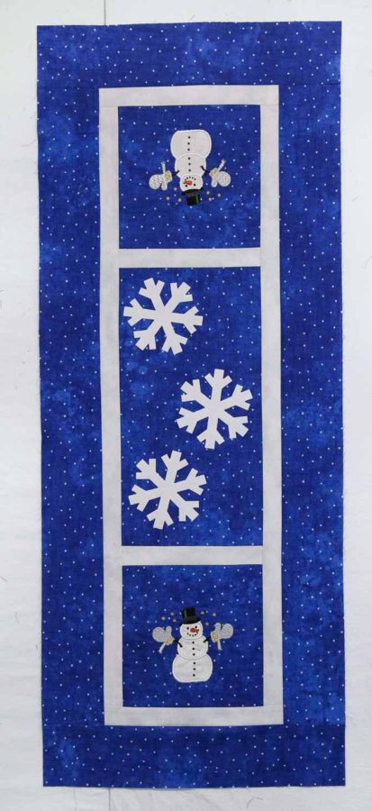 Auditioning snowflakes on the table runner