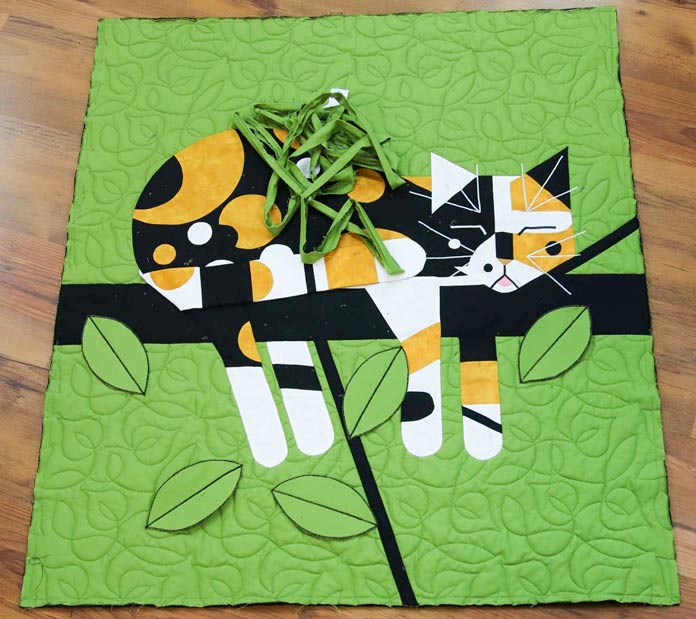 The quilt lies flat without the binding on.