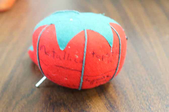Tomato pincushion used to store partially used needles
