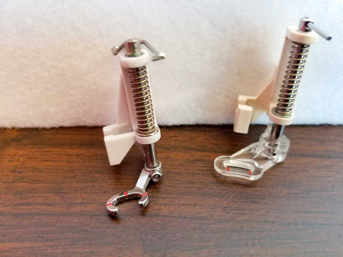 A metal Open Toe Free Motion Spring Action foot and a plastic Free Motion Spring Action foot