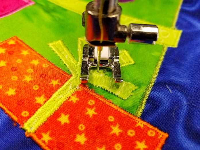 Pivot with the needle on the applique shape so you don't get gaps in the satin stitch