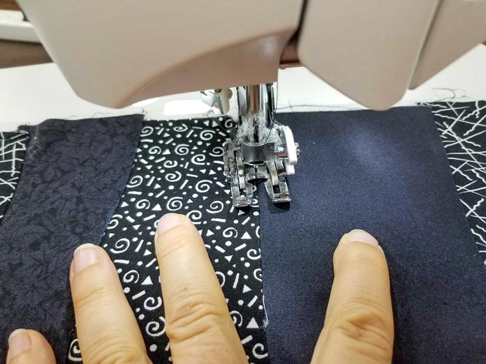 Gently pull the seam open so you can stitch in the ditch right at the intersection.