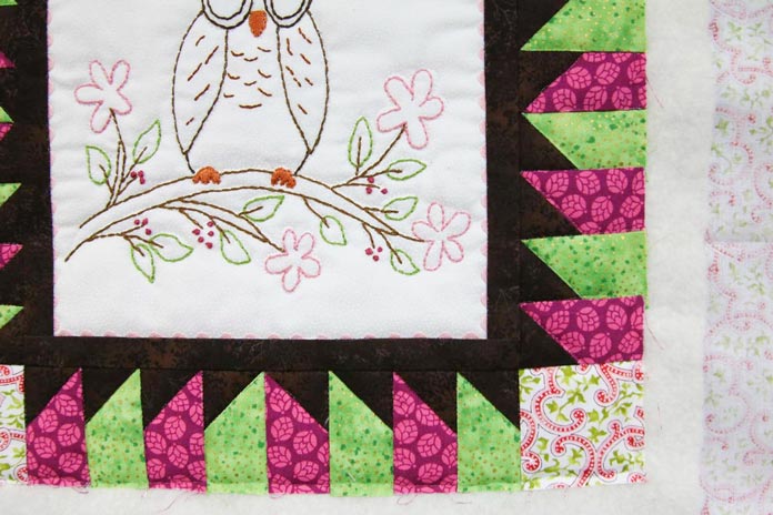 A close up of the quilting with invisible thread