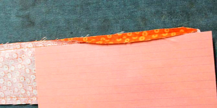 Index card used to fold over the seam allowance of the opening