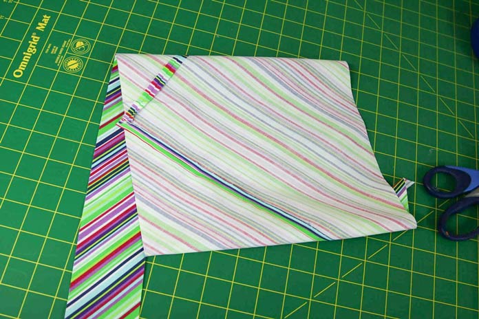 The offset tube of fabric is sewn and ready to be cut into one continuous strip for bias binding