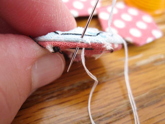 A fine quilting sharp needle helps to accurately catch just the edge of the fabric, and not the paper when joining hexi shapes together.