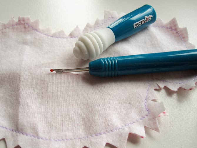 Use a seam ripper to slice through the muslin. The bodice piece is turned through this opening.