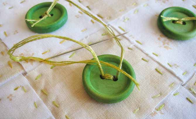 Sew the buttons to the heart, and then tie them for a decorative finish.