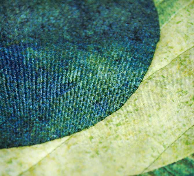 A close up of the blanket stitch used to secure the Stonehenge Elements circles to the quilt