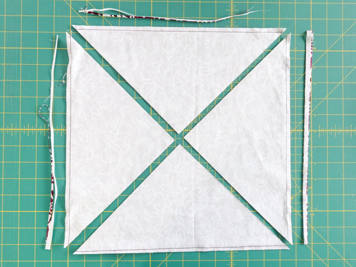 Trim the outer edge of the square then cut on the diagonal line.