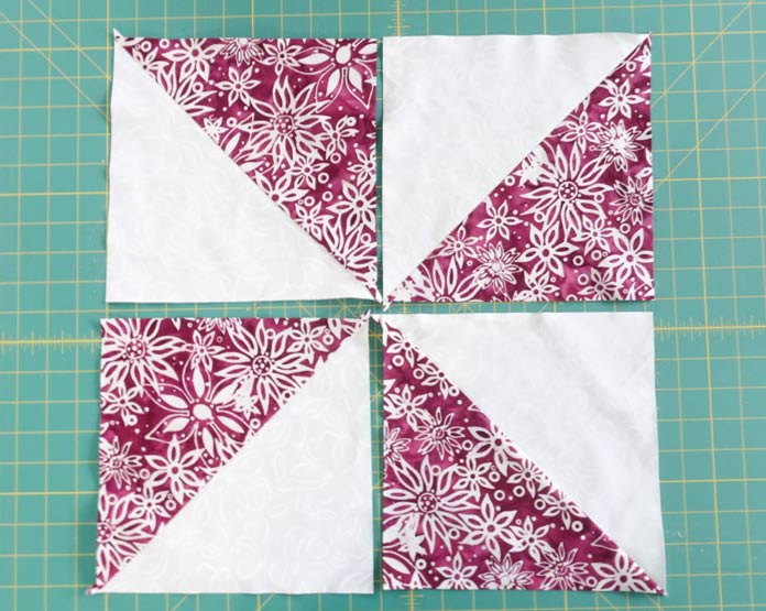 Press the Half Square Triangles to the darker fabric.
