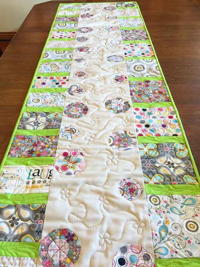 Modern table runner using fused circles to create flowers and piecing to make stems