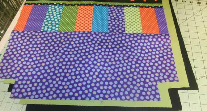 A 2" square is cut from each of the bottom corners of the tote bag front, the back, and the two lining pieces. Northcott.