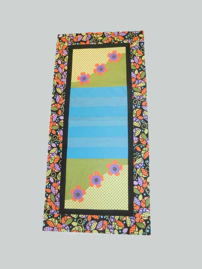 Landscape table runner with a small black inner border, and a larger leaf outer border. Northcott Urban Elementz.