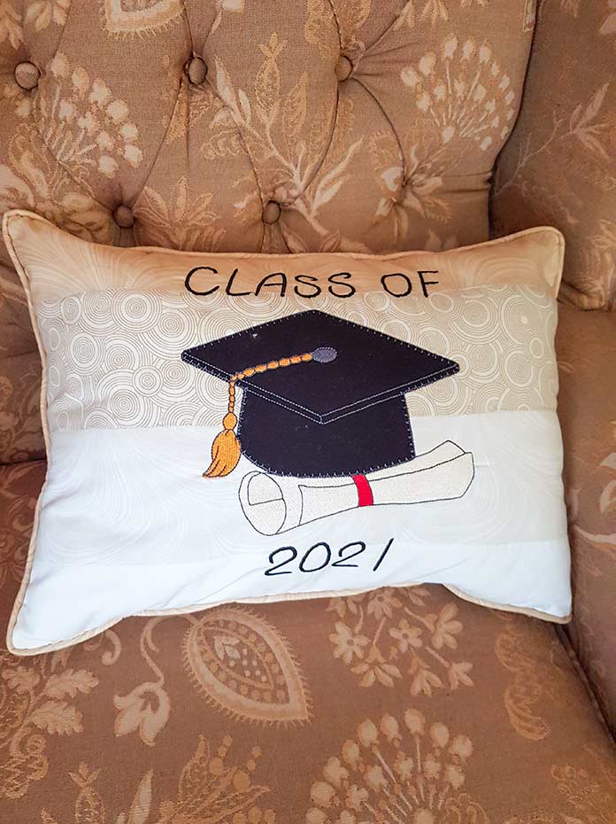 A 2021 mortarboard applique image on a decorative cushion