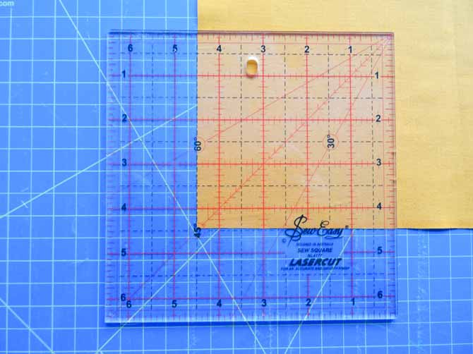 Using the SEW EASY Square Ruler - 6½" x 6½" to cut fabric squares for our modern quilt.
