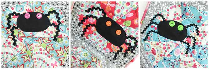 3 black fabric spiders with polka dot button eyes on a quilt.