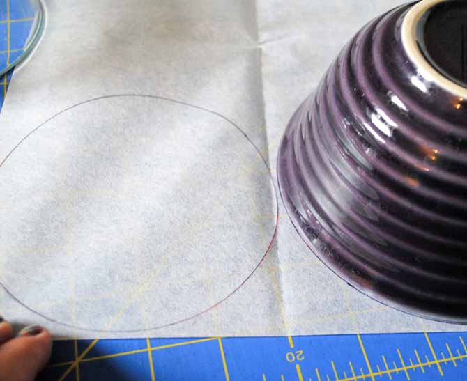 Using a bowl to make a circle shape on the paper side of the fusible interfacing