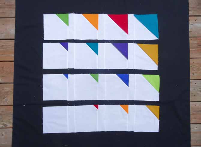 The 2" x 6½" white strips are sewn between each block.