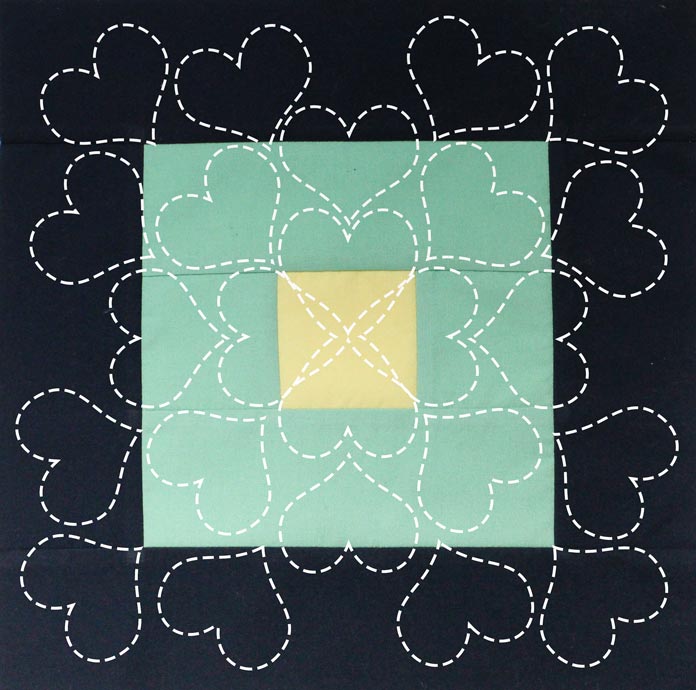 Free-motion heart quilting wreath is my idea for the blocks