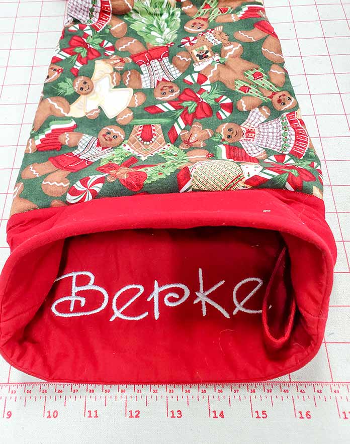 The cuff of a Christmas stocking turned inside out with the name Berke embroidered on it using the Husqvarna Viking Designer Brilliance 80