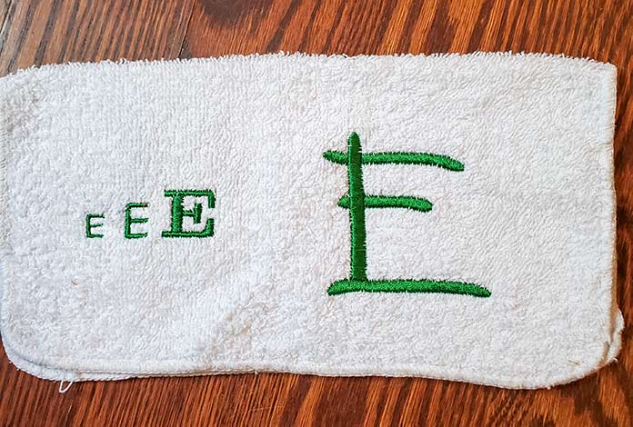 Samples of the letter E in green thread on white terry cloth using the Husqvarna Viking Designer Brilliant 80