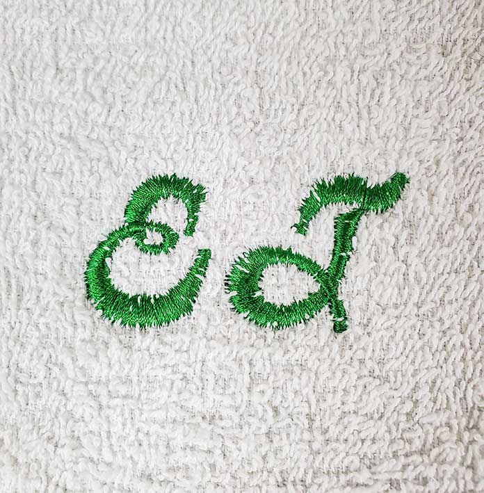 Embroidery stitches have sunk into the loops of the terry cloth
