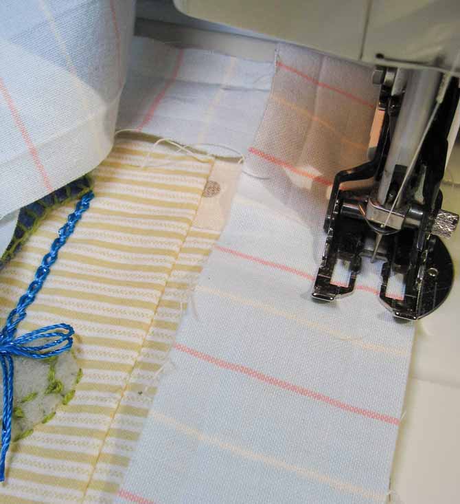 Binding strip sewn to the front of the mini quilt with the sewing machine's walking foot. WonderFil Specialty Threads.