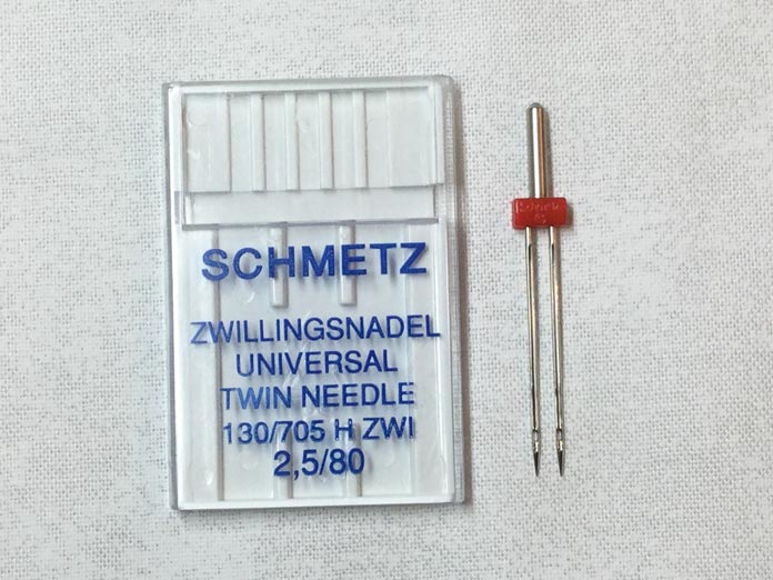 A SCHMETZ 2.5/70 twin needle is a nice size to learn twin needle free motion quilting