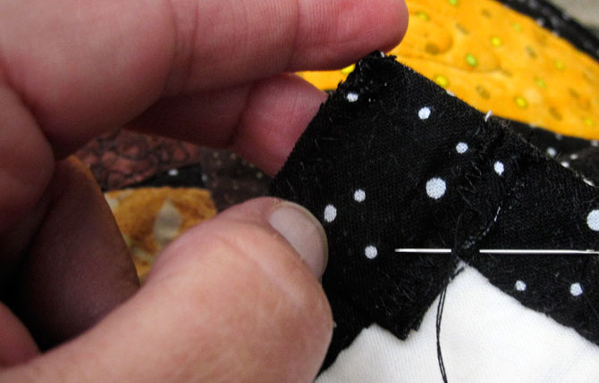 Stitch the magnet pockets to the corners of the Halloween Door Quilt.