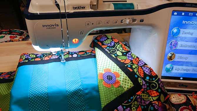 My table runner is back under my needle as I get ready to continue the faux applique stitch along another of the pieced seams