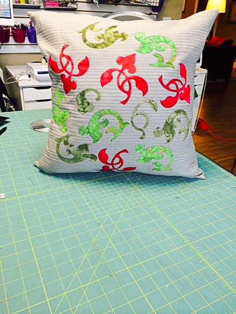 Banish Winter Blahs! Make this cushion for the holidays or to add color to your decor for the long winter ahead. The Brother ScanNCut was used to make the flourish designs! A pattern by Lynn Swanson for A Needle Pulling Thread Winter 2014/15 issue.