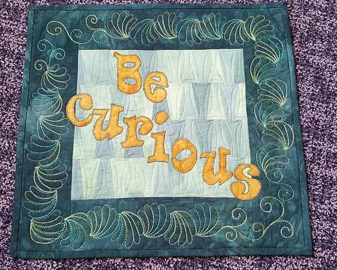 BE CURIOUS quilted wallhanging