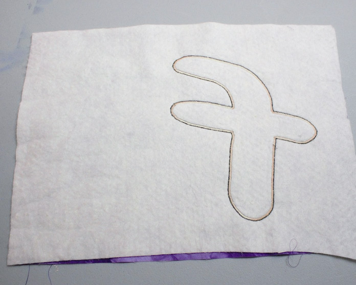 Use a satin stitch to secure the applique to the placemat.
