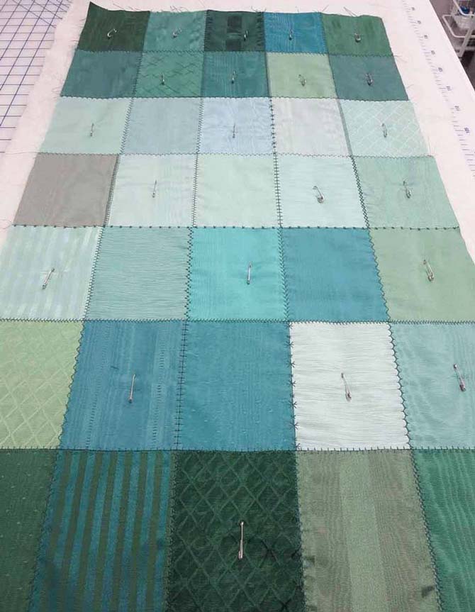 The table runner is pin-basted before quilting with the NQ900 sewing machine.