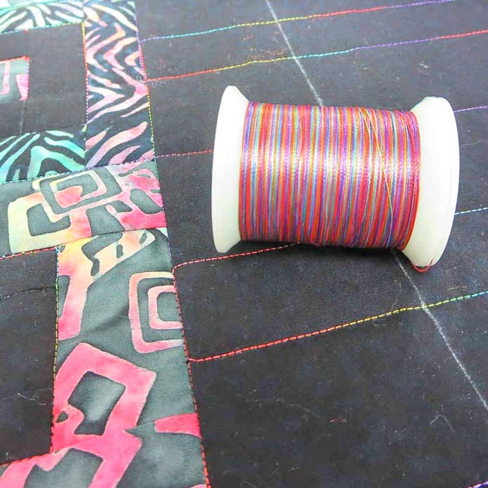 Use a variegated rayon thread and straight-line quilting.for an attractive finish.