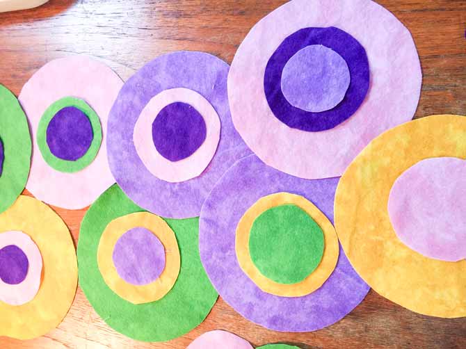 Flannel circles of various sizes stacked on top of each other on a desk.