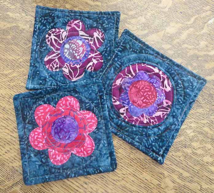 Finished coasters using HeatnBond EZ print sheets for the appliqué shapes and Therm Fleece for the batting